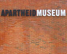 The symbolism-laden black and white lettering of the Apartheid Museum's entrance signage.