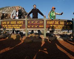 Tourists have their pictures snapped at the Cape of Good Hope sign at the southern point of the Cape Peninsula near Cape Town.