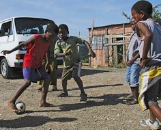 Township kids playing street soccer