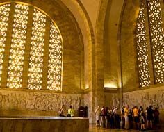 Visitors listen as their guide epxlains the history depicted in various freezes inside the Voortrekker Monument.