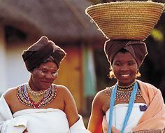 Ladies at Lesedi Cultural Village in tradtional Xhosa dress as a bride and family member.