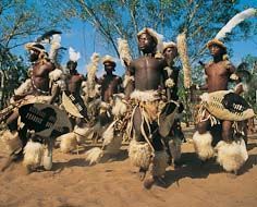 Zulu men performing traditional dances at a cultural village.